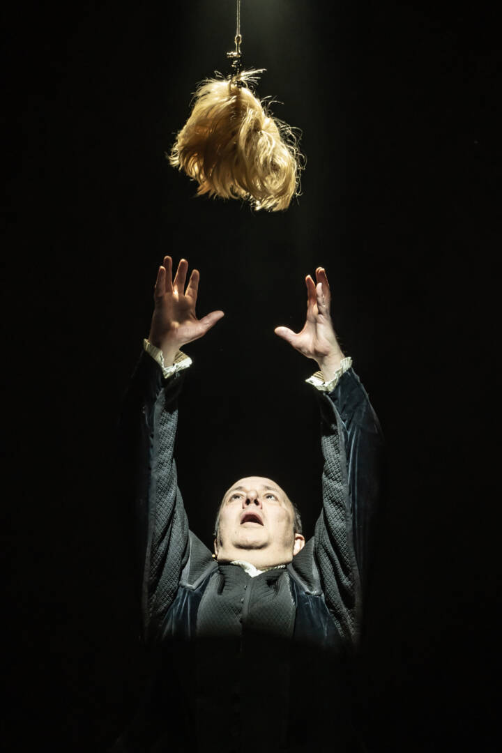 Paul Chahidi reaching for blonde wig